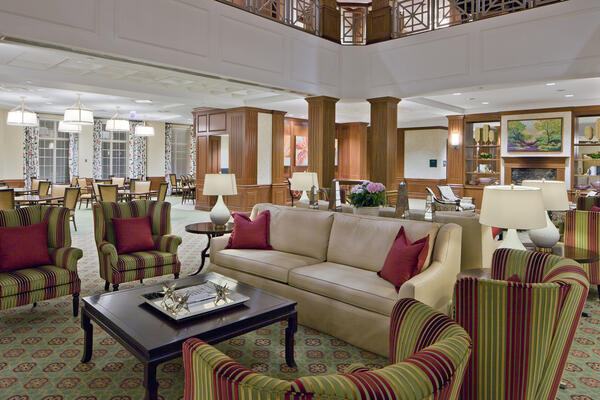 シニア リビング建設 - 長老派住宅レイク フォレストのリビング ルーム エリア、木工所の柱がある